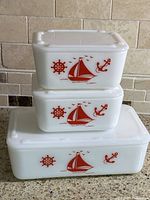 Front view of stacked dishes showing red nautical motif