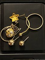 All jewellery pieces laid out on black surface