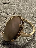 Side view of ring showing oval cabochon and prong setting