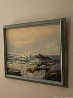 Framed seascape painting angled view