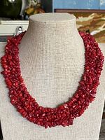Full view of red coral multi-strand torsade necklace on bust form