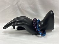 Both bracelets displayed on mannequin hand showing colors and bead size
