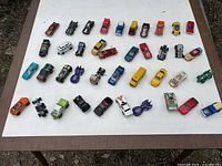 All 40 die-cast vehicles laid out on a white tabletop for full lot overview