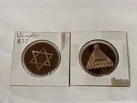 Star of David coin and triangular emblem coin in flips