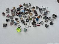 Full assortment of rings spread out on white surface