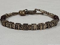 Full bracelet view showing letter cubes, crystals, heart charm, clasp