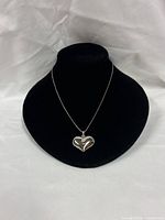 Full necklace on display bust showing chain and heart pendant