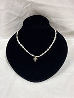 Full view of rice pearl necklace on display bust