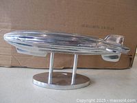 side view of polished aluminum zeppelin on stand