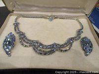 Necklace and earrings displayed inside original box