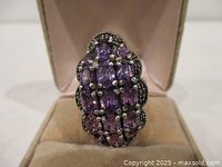 Front view of sterling silver cluster ring with purple stones