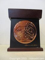 Front view showing copper bear plaque and signature