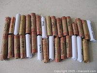 All 32 wrapped rolls of Canadian pennies arranged in rows