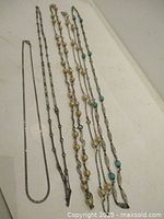 All five necklaces laid out full length