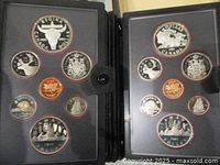 Both proof sets open, showing coins