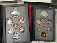 Open coin cases showing 1987 and 1988 proof coins