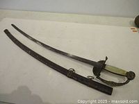 Full view of sword beside scabbard