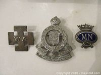 Front view of three Birks sterling pins and brooch