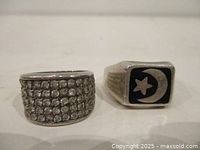 Front view of both sterling silver rings, pavé rhinestone band and black stone crescent star design