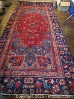 Full view of Persian Mashad rug laid out showing overall design and size