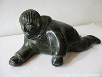 Full view of soapstone hunter sculpture