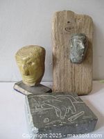 Front view of three Inuit stone carvings