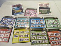 Overview showing nine stamp sheets, album book and brochure