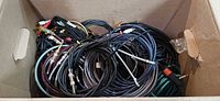 Top view of box showing assorted coiled audio cables with various connectors visible