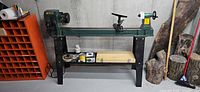 Full view of Craftex B2338 floor lathe on stand with accessories on shelf