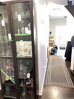 Full view of glass-front cabinet with contents (not included) showing exterior condition