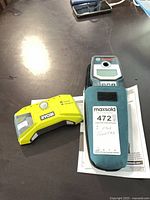 Ryobi stud finder, Bosch stud finder in case, manual visible