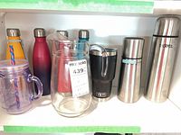 Shelf view showing entire lot including bottles, pitcher, mason cup and YETI tumbler