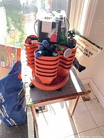 Stacked planters on caster base with tools, soil bag, table