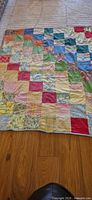 Full view of quilt laid flat showing patchwork pattern and binding