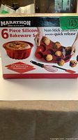 Retail box showing Marathon 6-piece silicone bakeware set in red