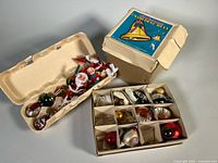 Overview of lot showing three boxes with assorted ornaments