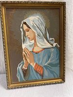 Full view of framed painting showing Virgin Mary in prayer