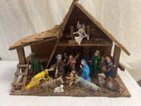 Overall nativity set inside wooden stable