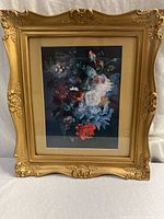 Full view of framed floral print standing upright.