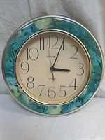 Front view of clock showing floral border and face