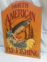 Front view of plaque showing trout relief, background and text