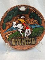 Full view of round Wyoming plaque on stand