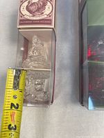 Two boxed sets of clear glass turkey items with measuring tape shown