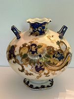 Front view of porcelain vase showing body decoration and handles