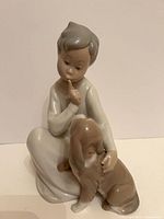 Front view of Lladro porcelain figurine, child with dog
