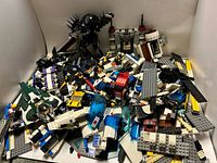 Overall pile of mixed LEGO pieces, minifigures and builds