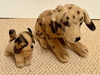 Front view of both Steiff dogs side by side