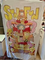 Full front view of towel held vertically showing entire SUN FUN design