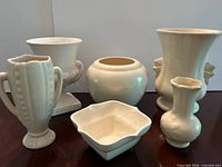 All six cream/off-white ceramic pieces grouped together
