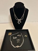 Overview of all jewelry on bust and tray